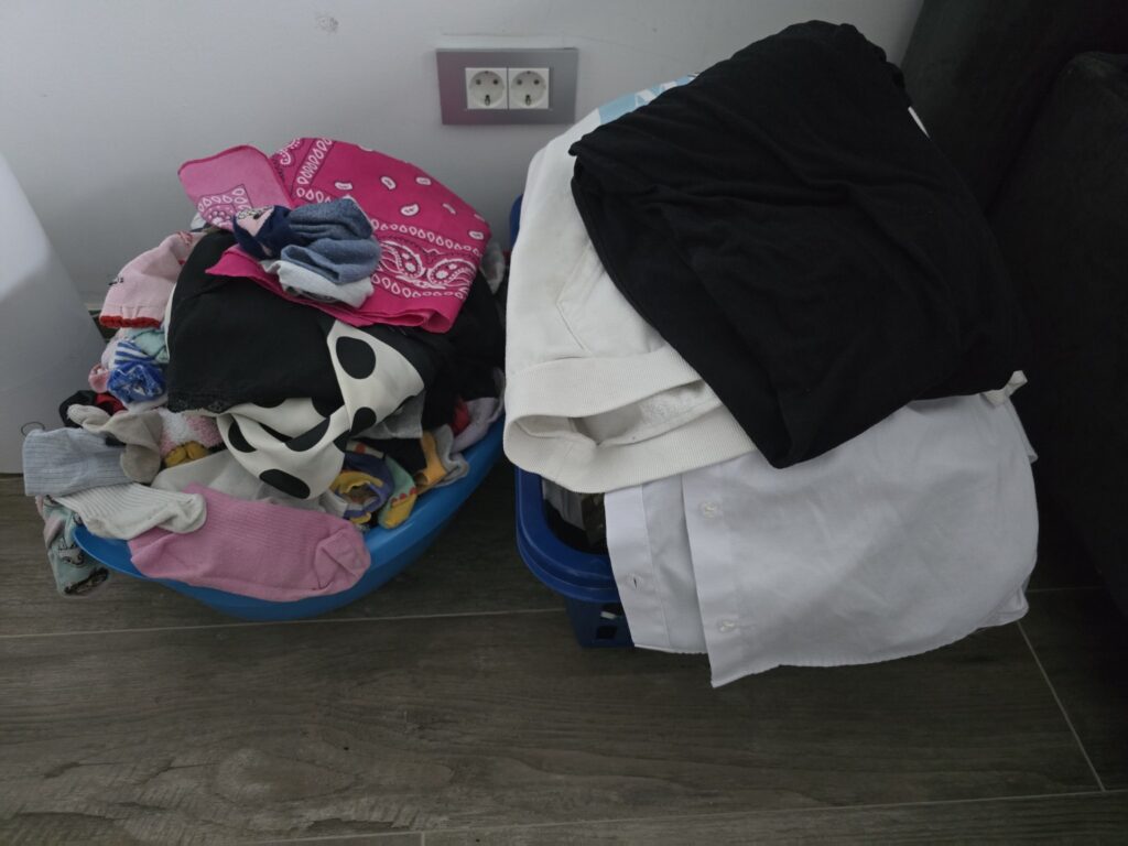 Laundry baskets with clothes waiting to be ironed and unmatched socks
